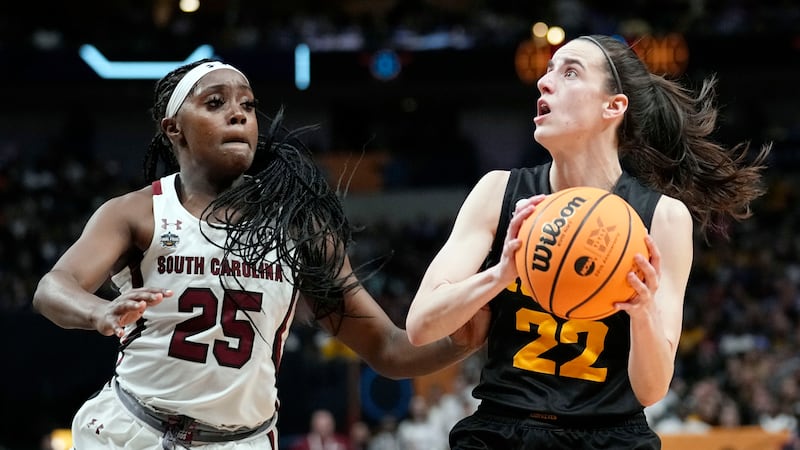 FILE - Iowa's Caitlin Clark looks to shoot past South Carolina's Raven Johnson during the...