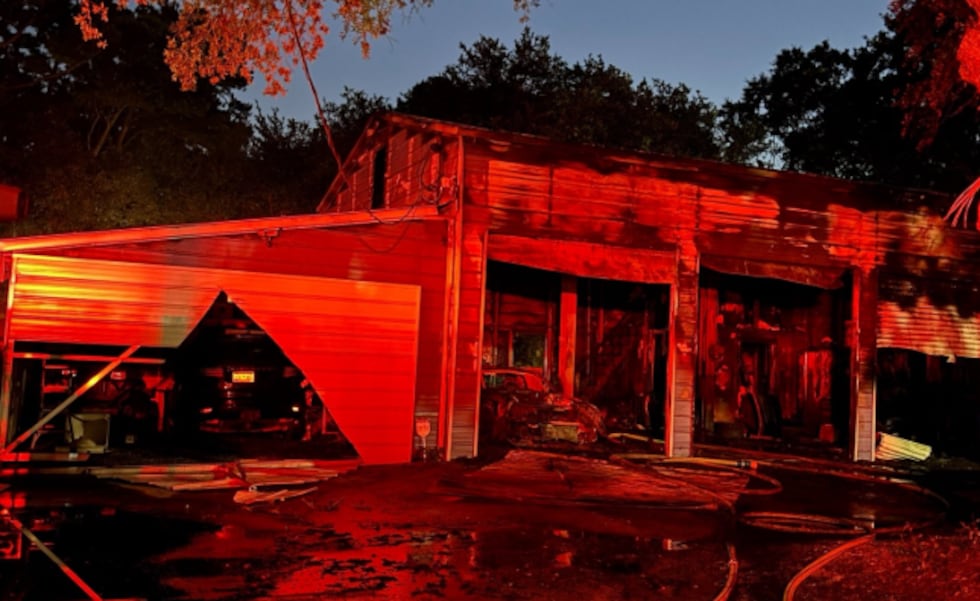A fire severely damaged a Charleston body shop Friday morning.