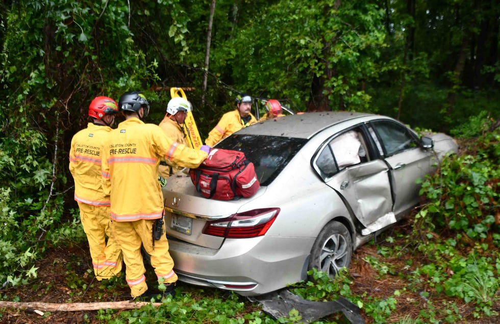 A woman has been hospitalized after a crash left her trapped in her vehicle.