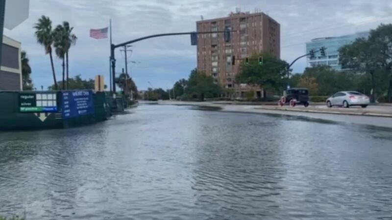 Coastal flooding and high tides closed roadways in downtown Charleston for the fourth straight...