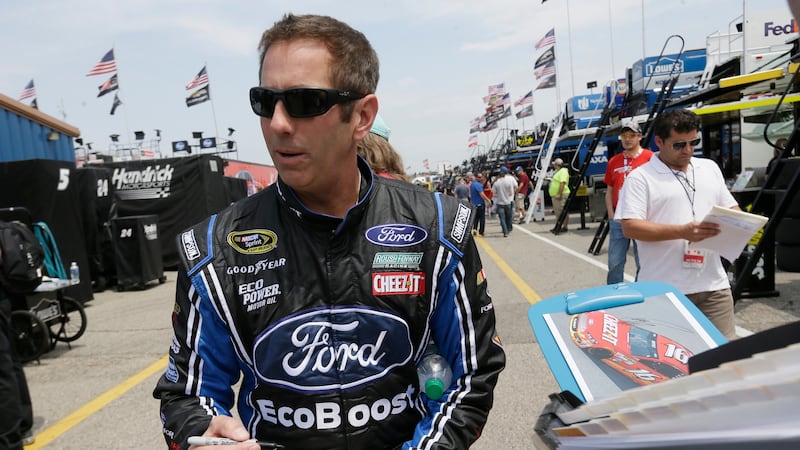 Greg Biffle signs autographs before a practice session for the NASCAR Sprint Cup series auto...