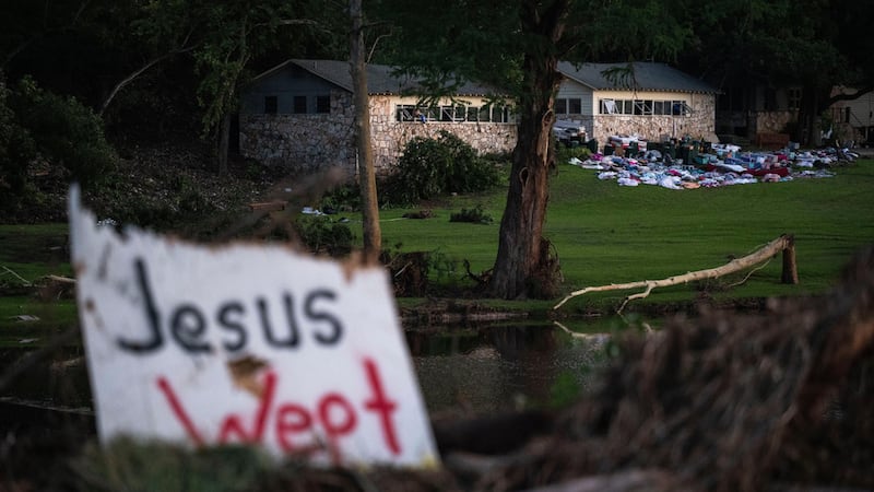 FILE - Campers' belongings sit outside one of Camp Mystic's cabins near the Guadalupe River,...