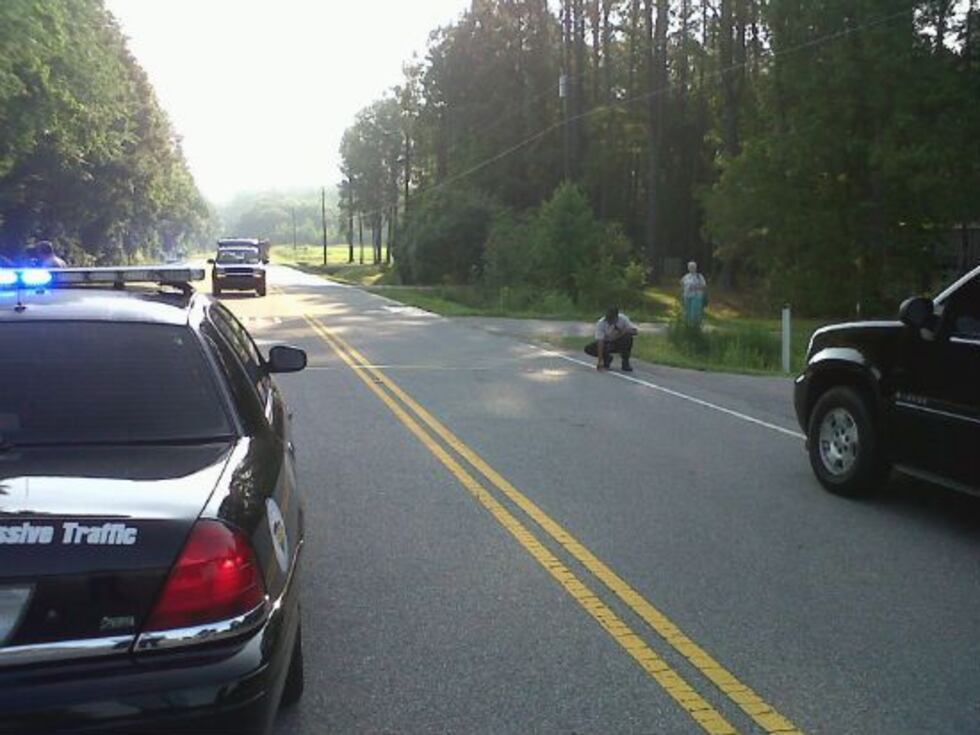 Police block off the highway to investigate Friday morning's shooting.