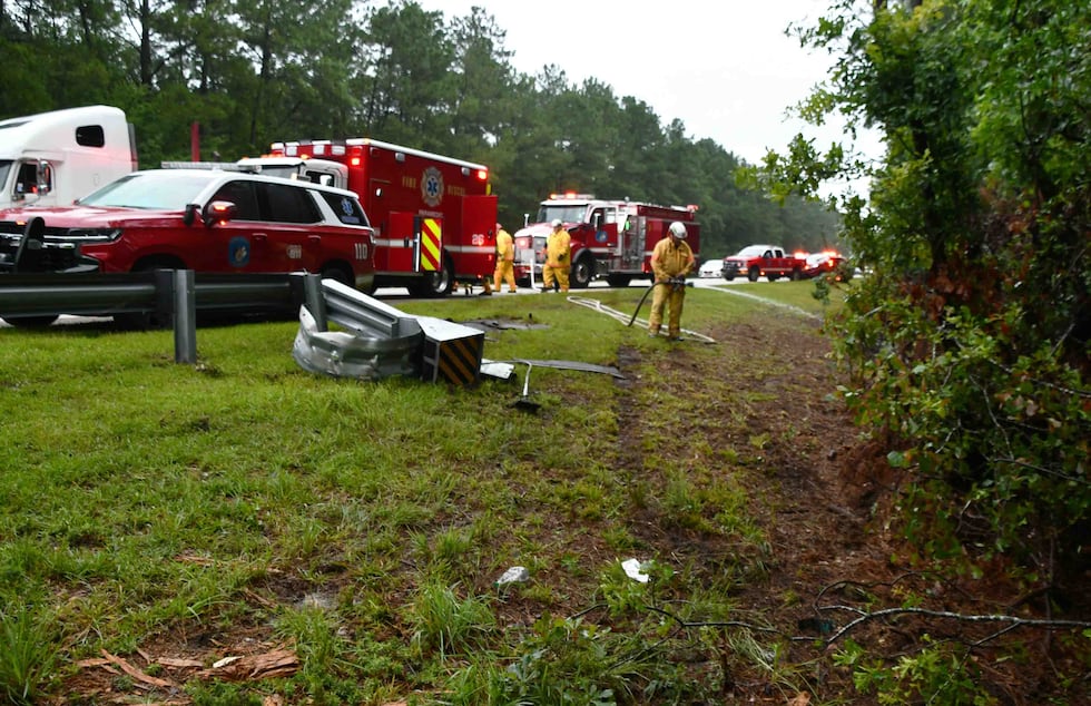 A woman has been hospitalized after a crash left her trapped in her vehicle.