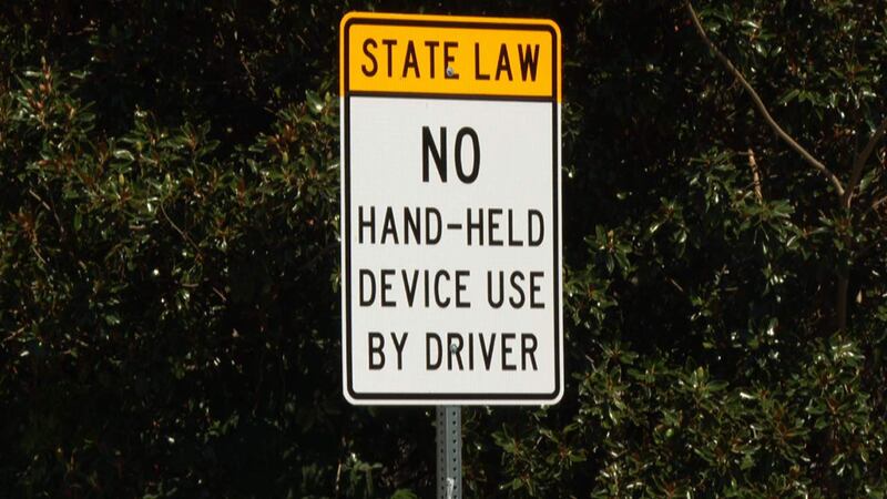 A sign reminding drivers of South Carolina’s new hands-free driving law stands at an entrance...