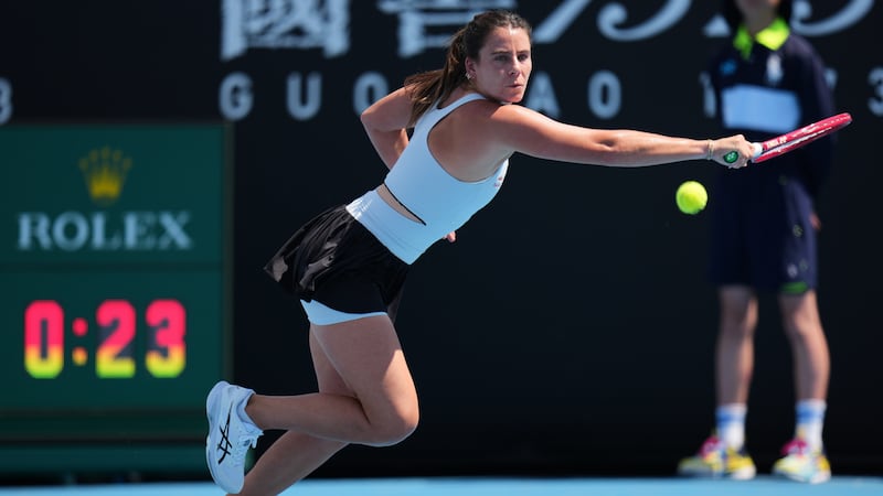 Emma Navarro of the U.S. plays a backhand return to Magda Linette of Poland during their first...